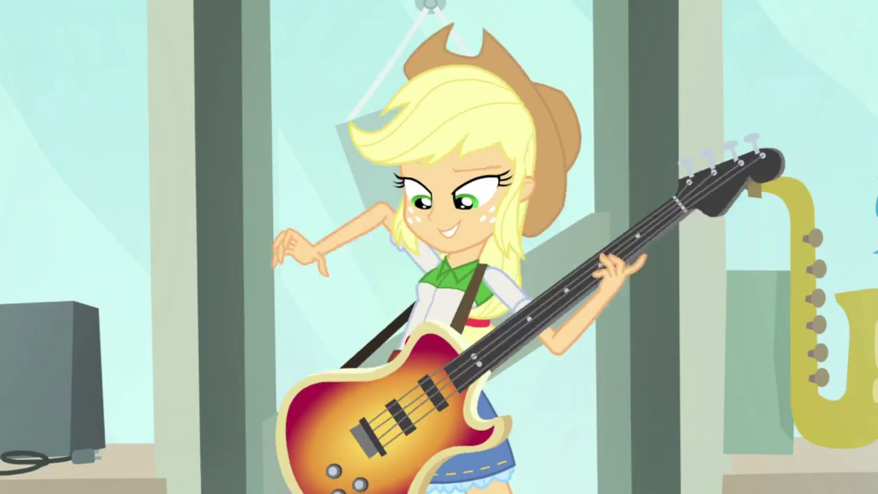 Applejack confidently plays her bass guitar in A Case for the Bass, a short from My Little Pony Equestria Girls Rainbow Rocks, highlighting her musical talent.