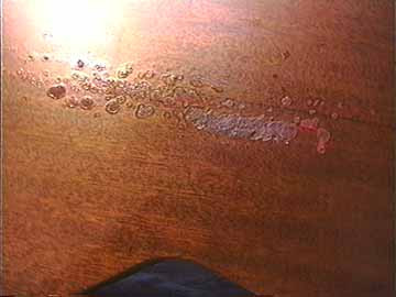 Vinyl strap damage to the back of a Martin guitar