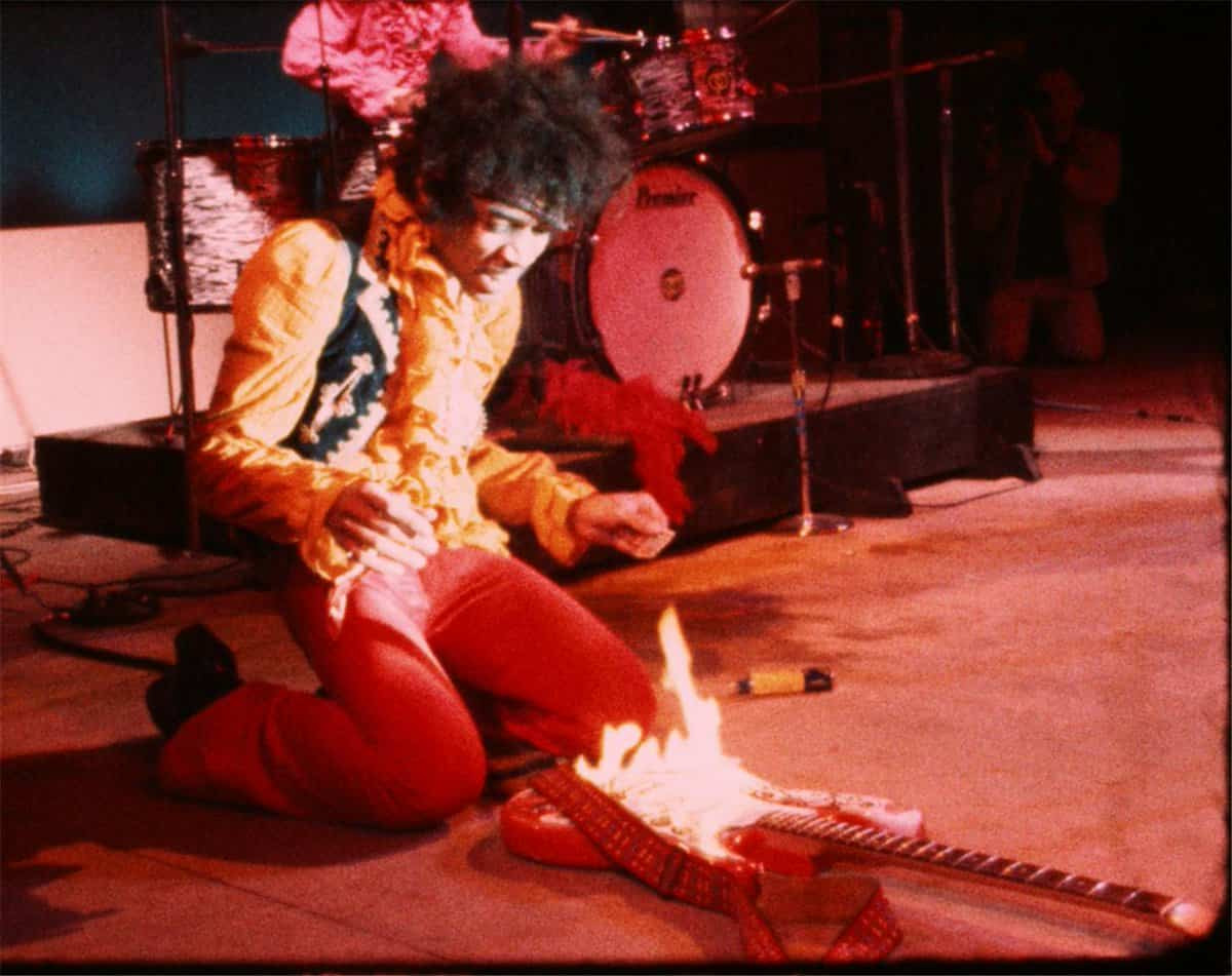 Jimi Hendrix setting his Stratocaster ablaze at the Monterey Pop Festival in 1967, a defining moment in rock history.