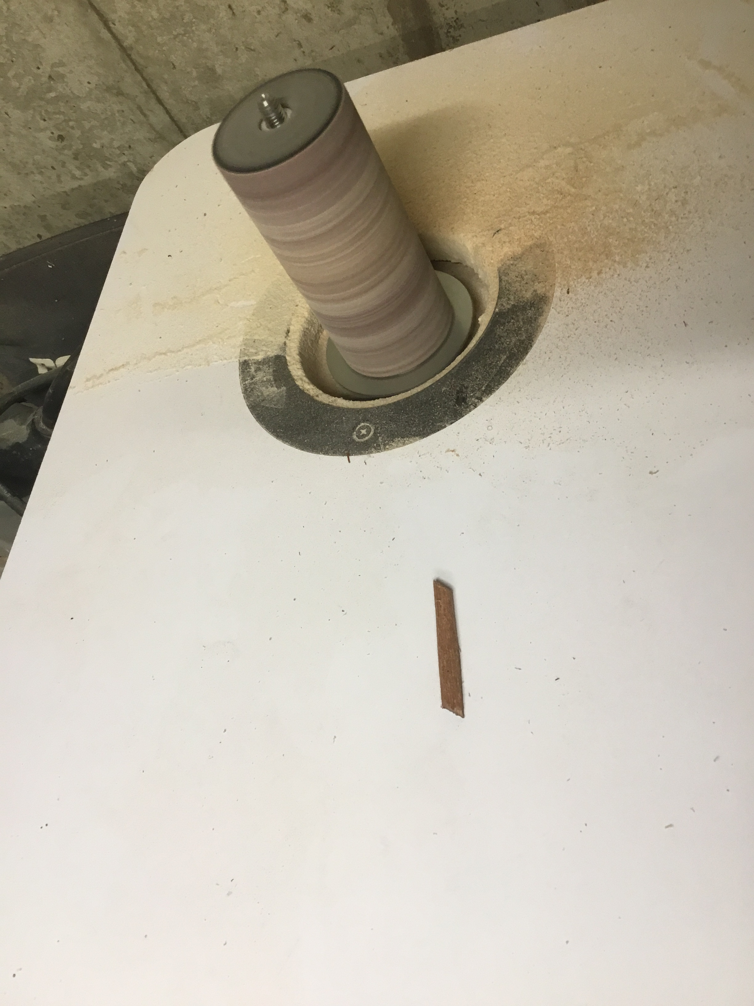 Using a spindle sander to refine and finish the shaped wooden bindings