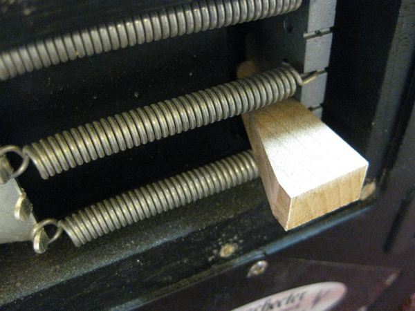 A wedge tool used to stabilize a Floyd Rose tremolo for easy tuning and spring adjustment