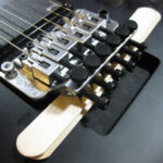 Popsicle sticks used to prop up a Floyd Rose bridge for easy string changes