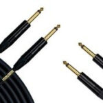 Four connectors for Mogami guitar cables with a coiled section in the corner