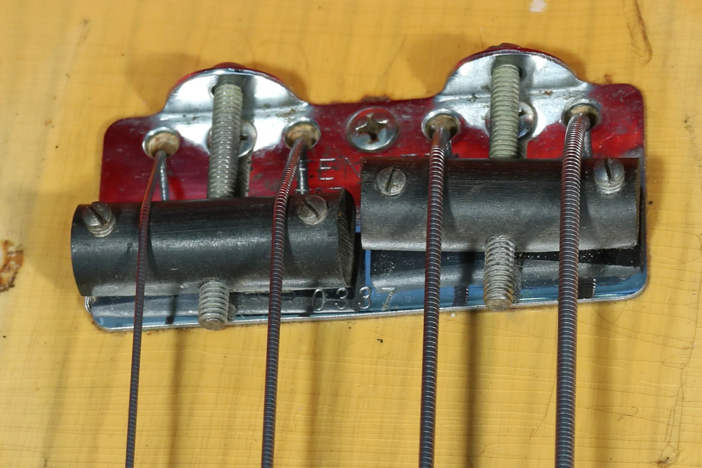 Close-up of a 1952 Precision Bass bridge plate showing the serial number and date.