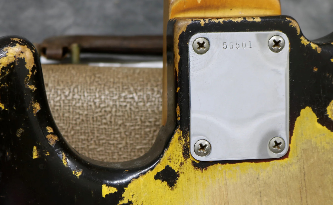 Image showcasing the neck plate of a 1960 Jazz Bass, highlighting the serial number location.