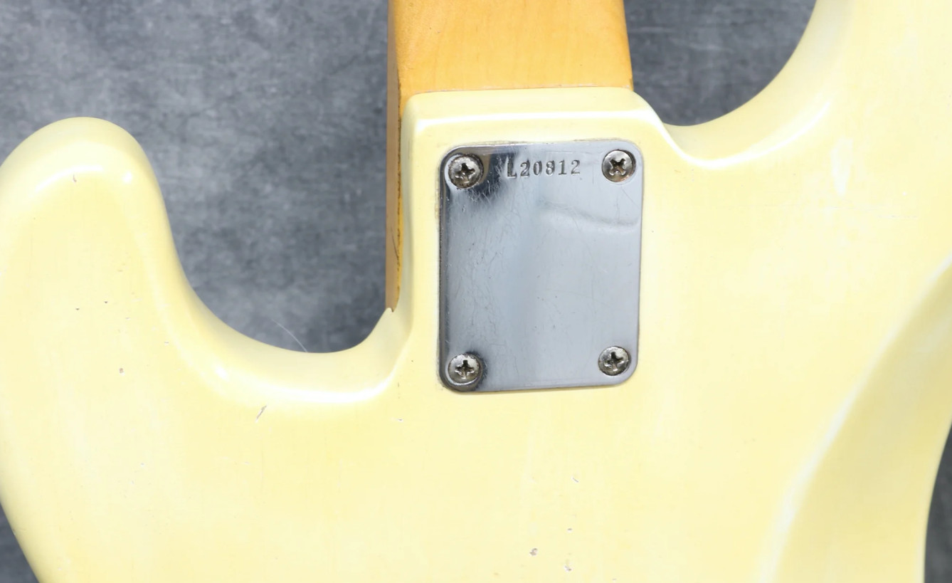 Image of a 1964 Precision Bass neck plate with an L series serial number, emphasizing the 'L' prefix.