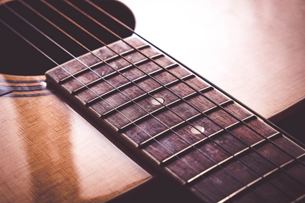 Guitar strings close up showing dirt