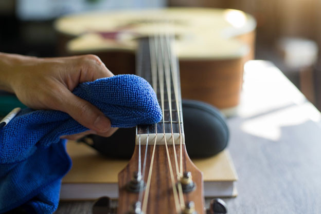 Guitar cleaning tools including cloths and string cleaner