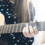 girl playing the guitar