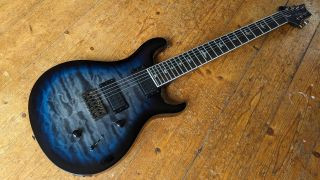 Angled shot of a PRS SE Mark Holcomb SVN 7-string electric guitar in blue finish