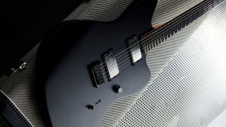 Front view of a white Fender Jim Root Jazzmaster V4 electric guitar on a black guitar case