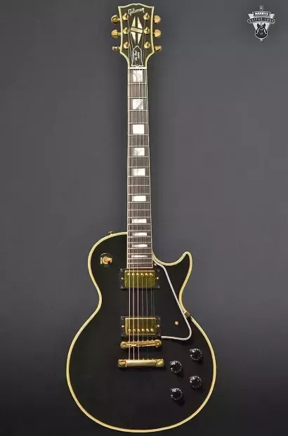 A Gibson Les Paul Custom in Ebony finish, highlighting its multi-ply binding and gold hardware, ideal for heavy music