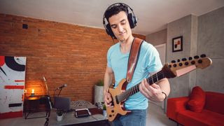 Guitarist wearing headphones during a practice session