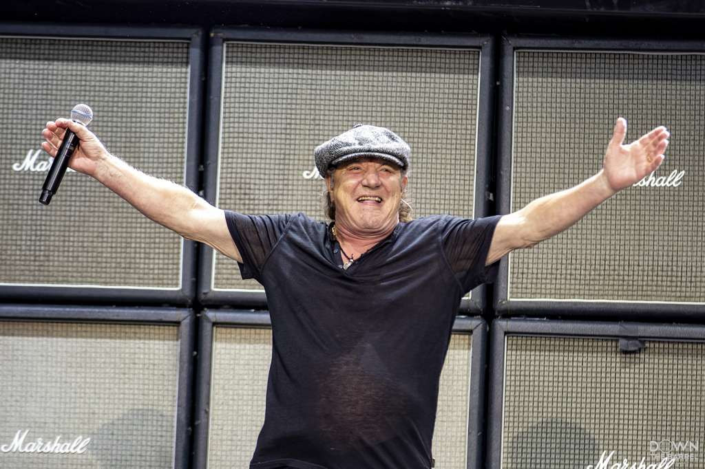 A wide shot of the AC/DC stage and crowd, with Angus Young playing guitar center stage.