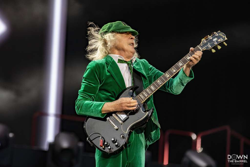 AC/DC band performing &quot;T.N.T.&quot; with Angus Young center stage and cannons visible.