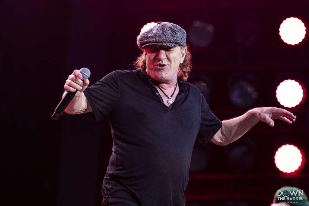 AC/DC performing &quot;Whole Lotta Rosie&quot; with Rosie image on screen and Angus Young playing guitar.