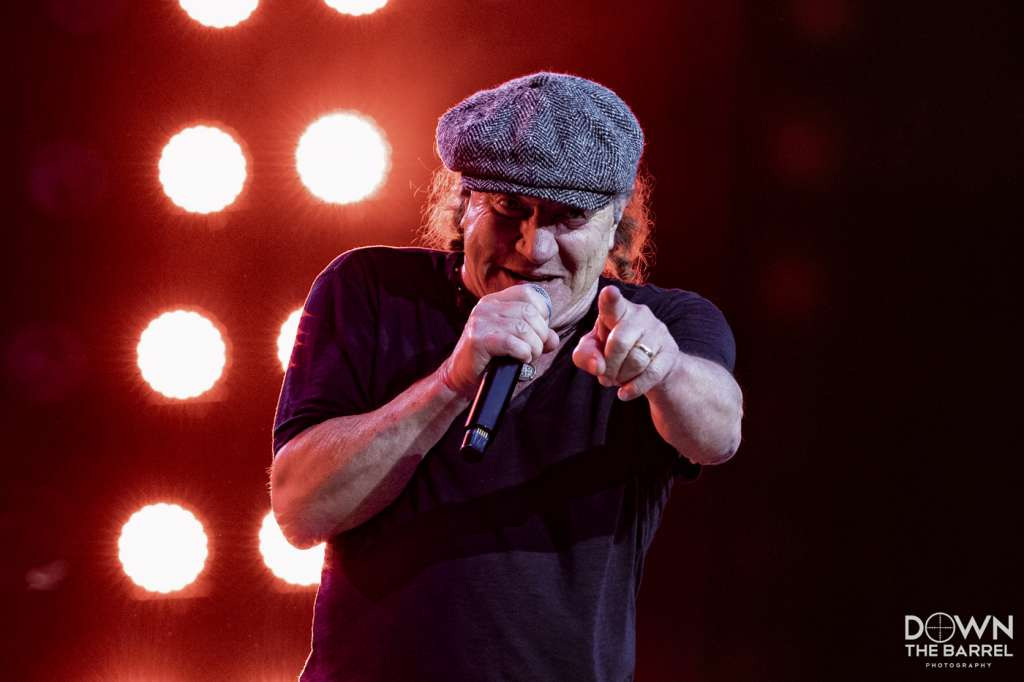 AC/DC performing &quot;Highway to Hell&quot; with stage lighting and crowd in silhouette.