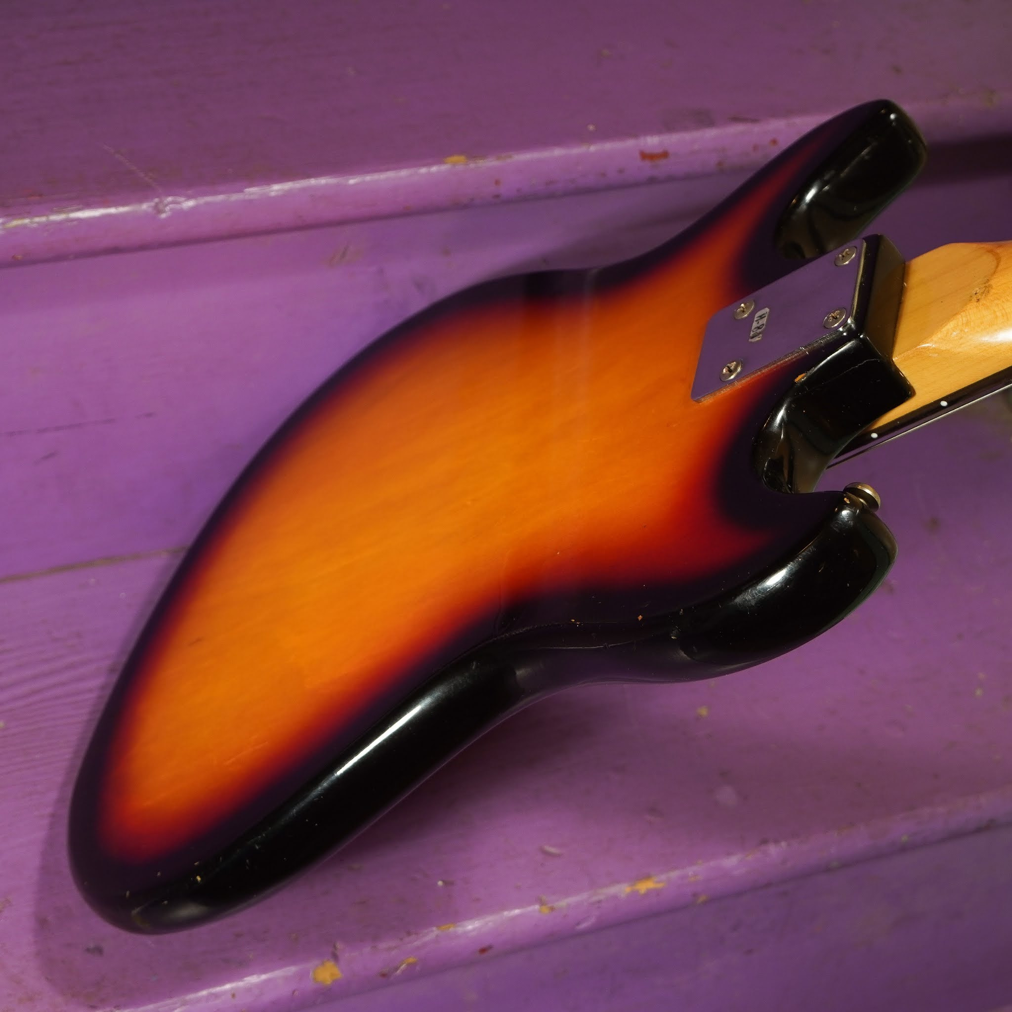 Image of the guitar headstock from a different angle, showing the tuners and string tree, emphasizing the vintage hardware.