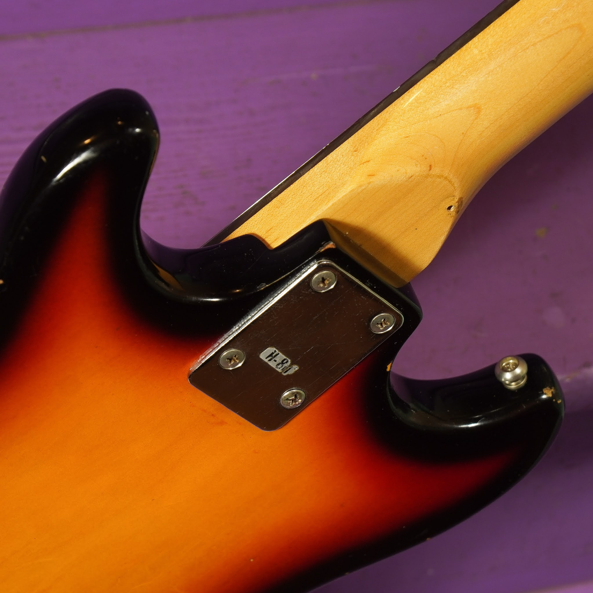 Rear view of the Harmony electric guitar, showing the neck joint and body contours.