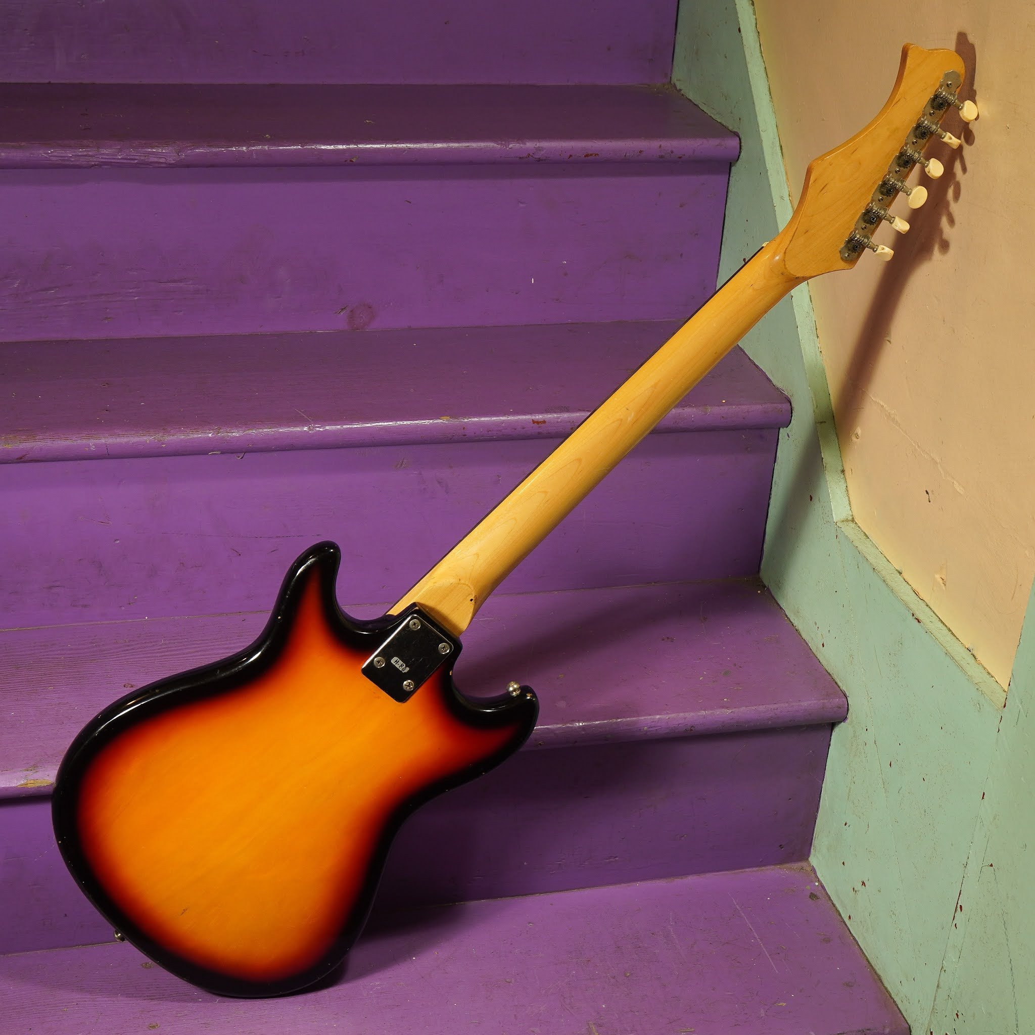 Image showing the guitar inside its case, highlighting the included period-appropriate chipboard case.
