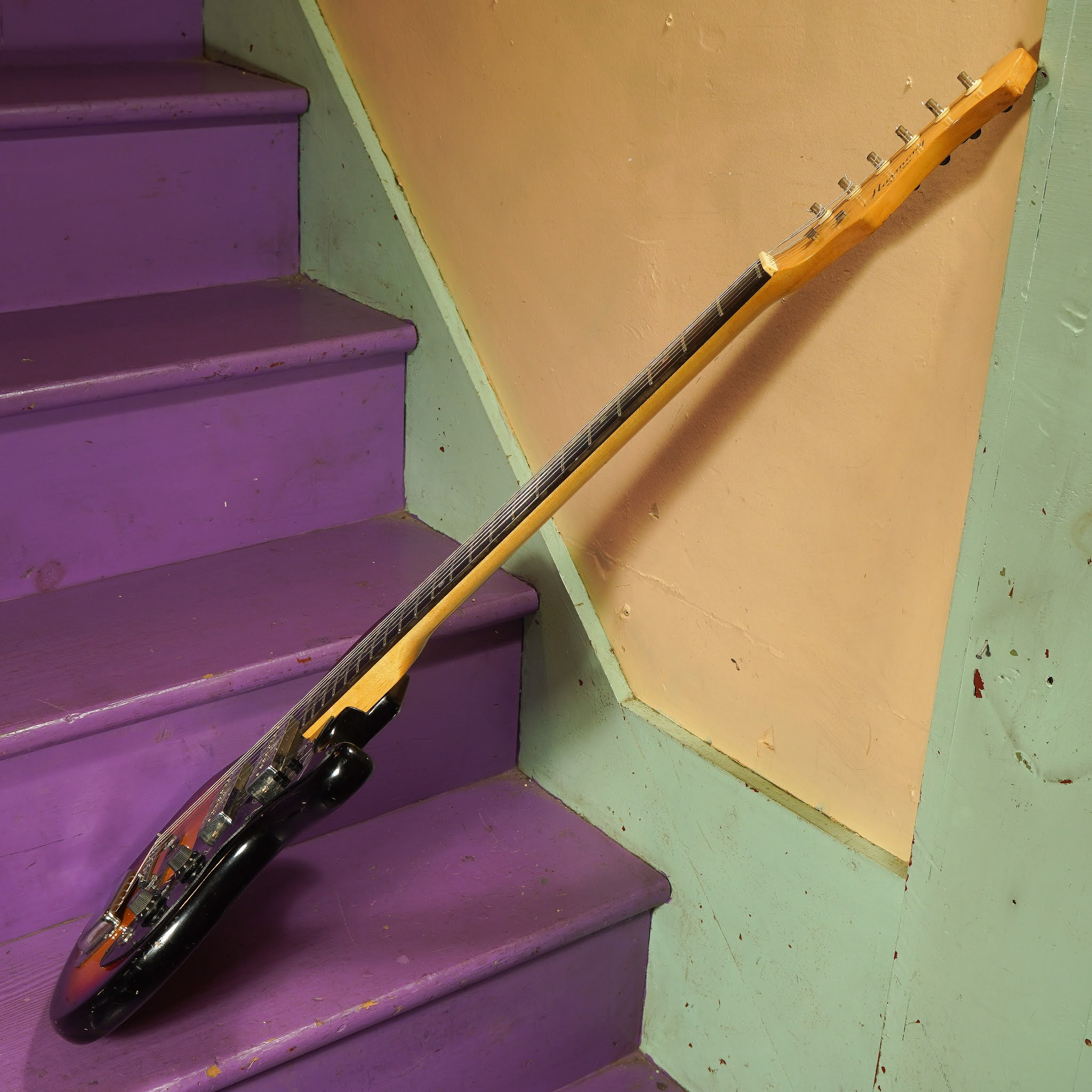 Angled shot of the Harmony electric guitar, capturing the overall design and vintage vibe of the instrument.
