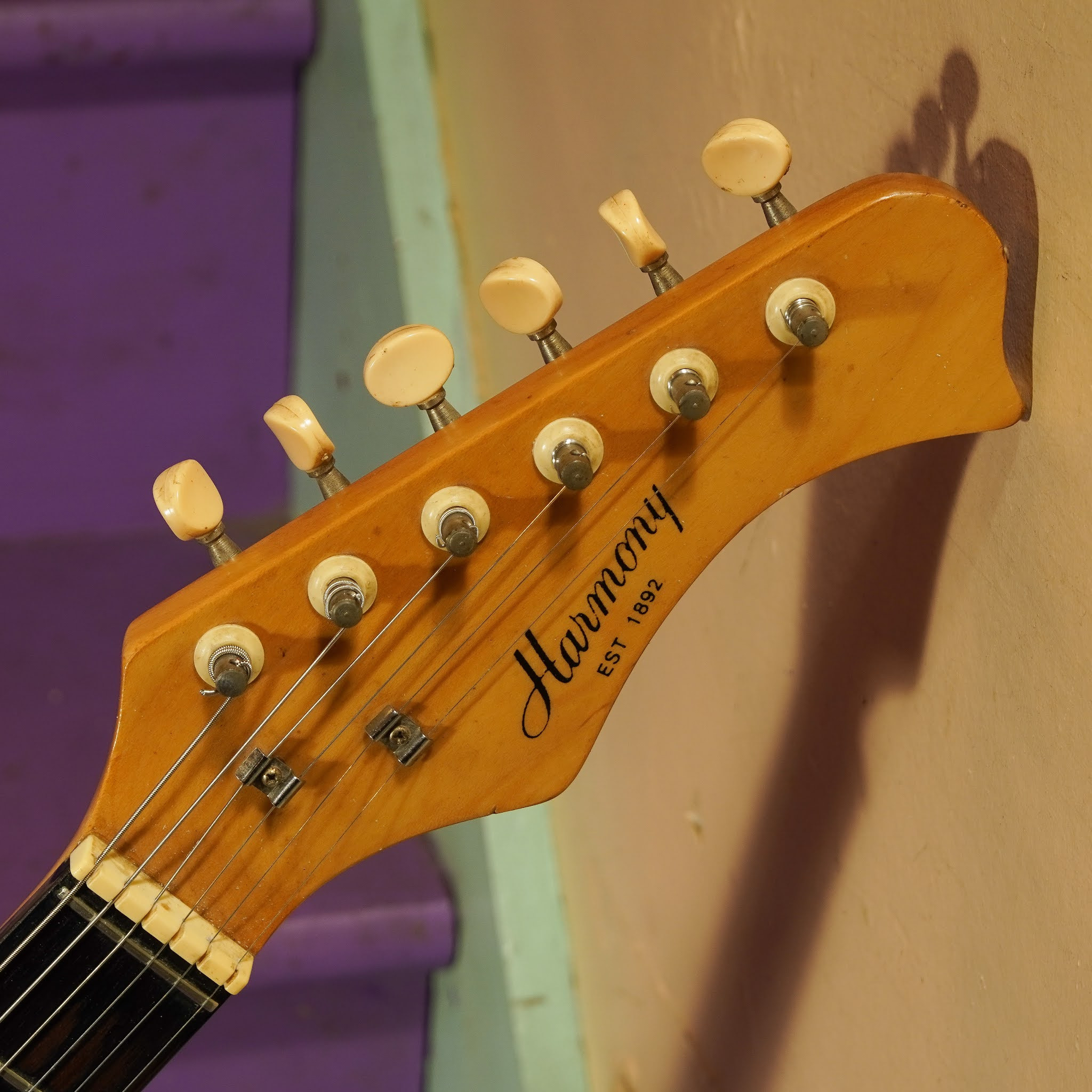 Detailed view of the guitar body, showcasing the finish, pickups, and bridge, emphasizing the vintage aesthetics and hardware.