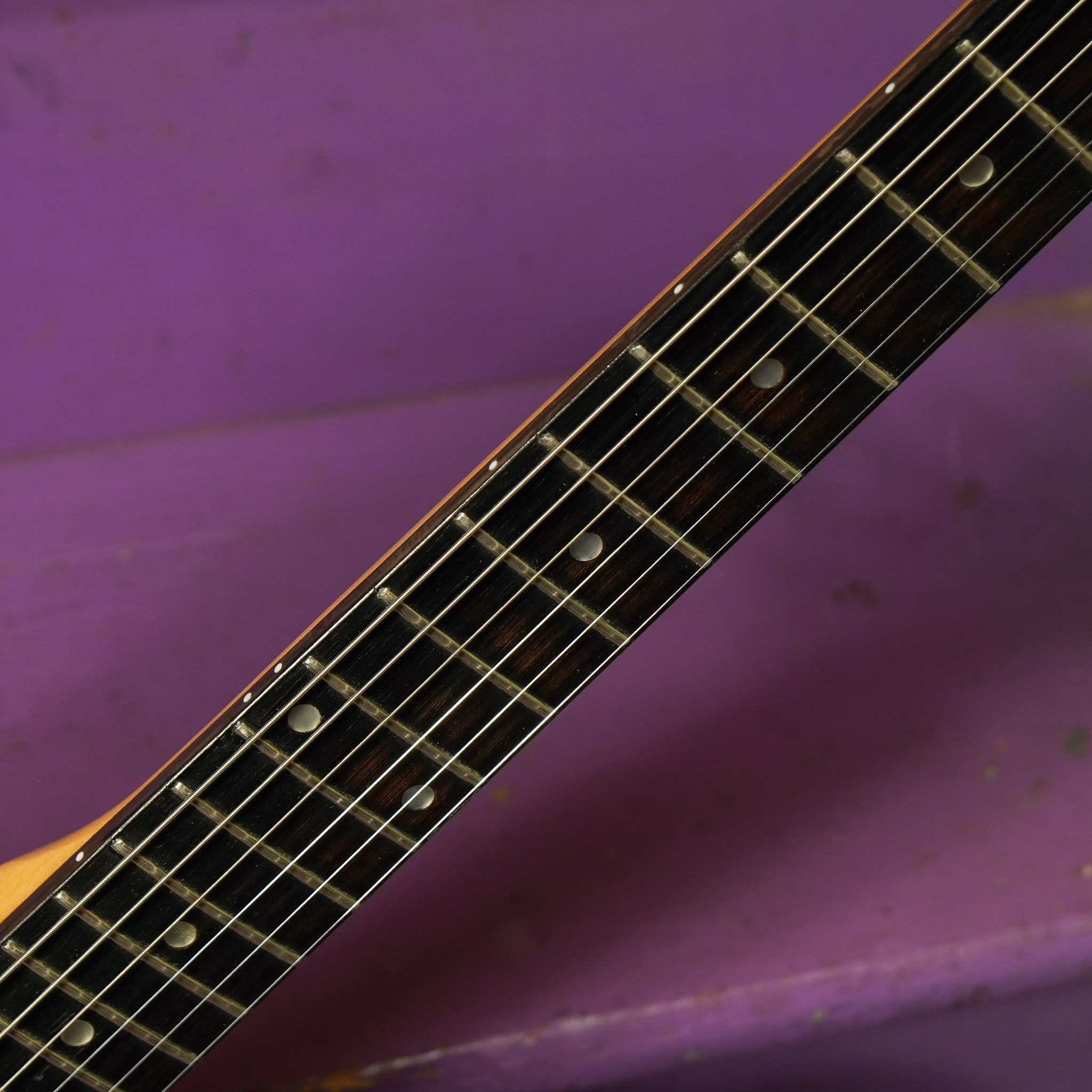 Image highlighting the guitar's neck and fretboard, showcasing the added side dots and fret condition after the fret level and dress.