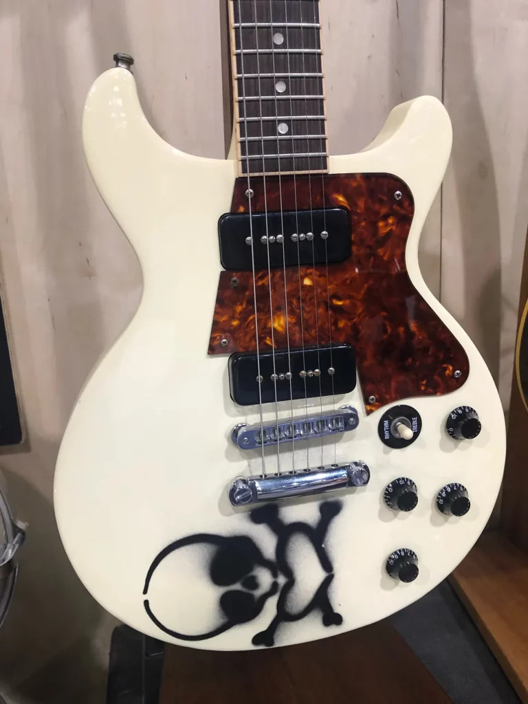 Close-up of Billie Joe Armstrong's white Les Paul Special DC guitar with a skull graphic, a prototype for his signature model.