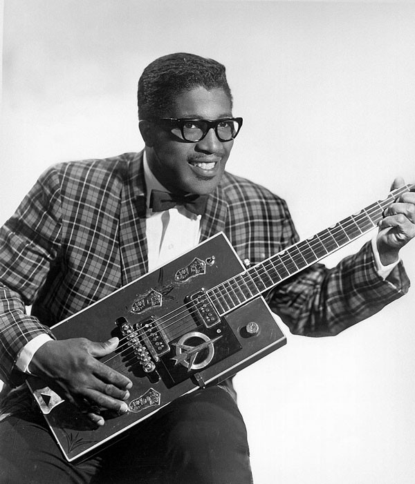 Bo Diddley, a rock and roll pioneer, pictured in a 1957 publicity shot holding his iconic rectangular &quot;Twang Machine&quot; Gretsch guitar.