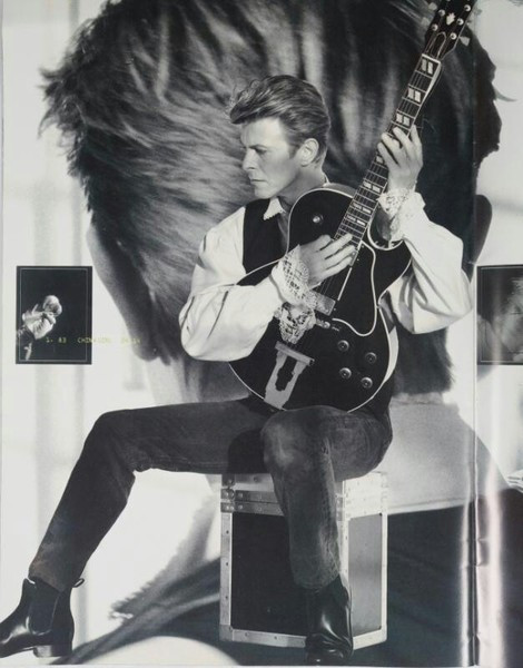 David Bowie playing his black Gibson L4 guitar