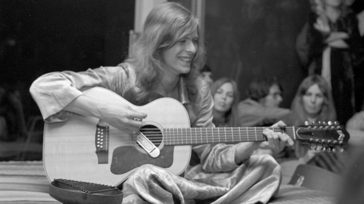 David Bowie performing live in 1971 with a Guild 12-string acoustic guitar