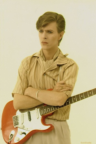 David Bowie playing a red Fender Stratocaster