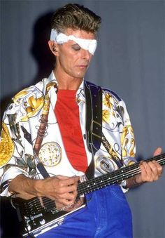 David Bowie playing his custom silver Steinberger GL2 guitar