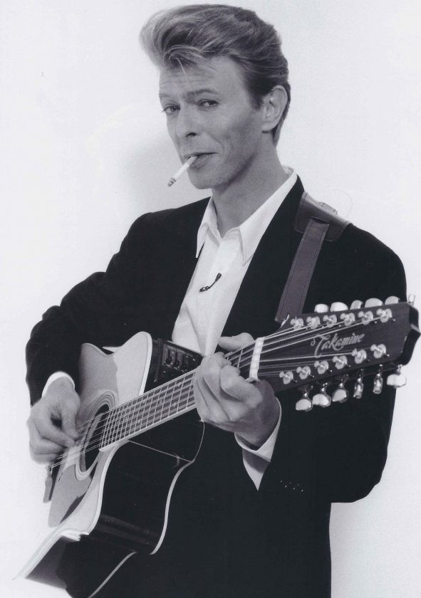David Bowie playing his Takamine FP 400SC 12-string acoustic guitar