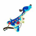 Toddler happily playing with the Woofer puppy guitar in electric mode