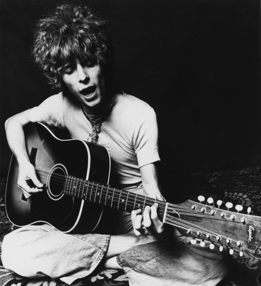 David Bowie posing with his Espana 12-string acoustic guitar in 1969
