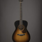 David Ryan Harris playing his custom Yamaha acoustic guitar, showcasing its tobacco burst finish and body shape