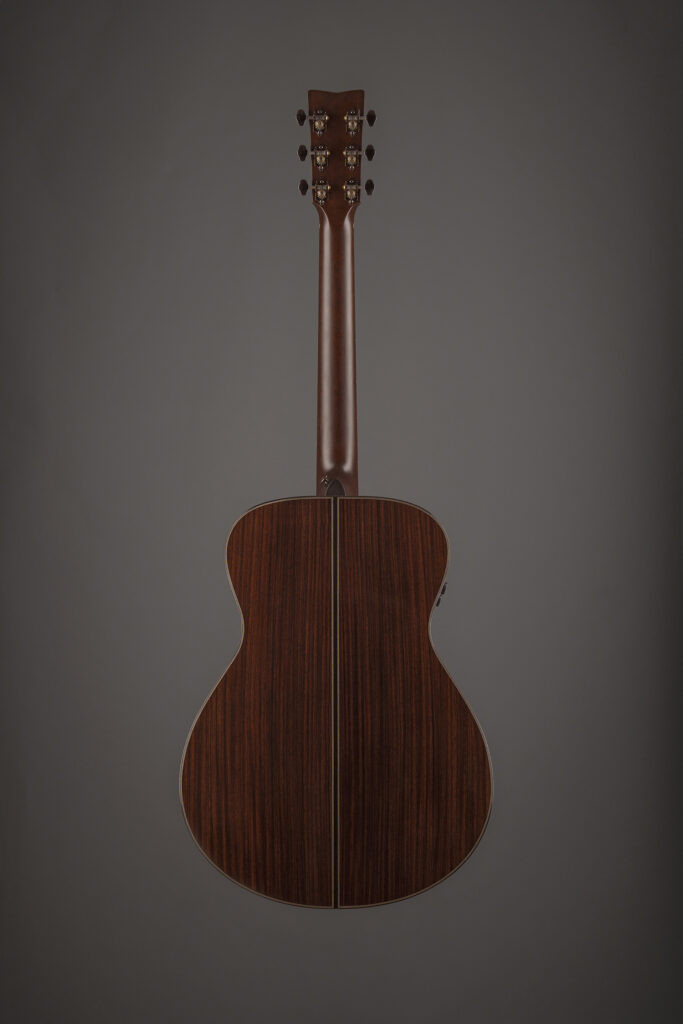Close-up of the Yamaha guitar headstock and tobacco burst finish, highlighting the vintage aesthetic