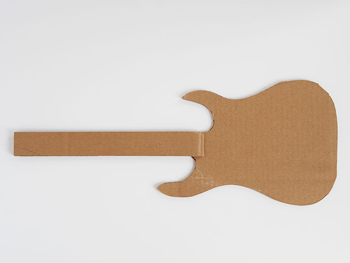 Step 3: Gluing cardboard strips to the back of the guitar for neck reinforcement