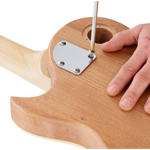 Harley Benton DIY guitar kit bodies in various stages of assembly, showcasing different wood grains
