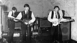 Paul McCartney playing his iconic Hofner bass guitar