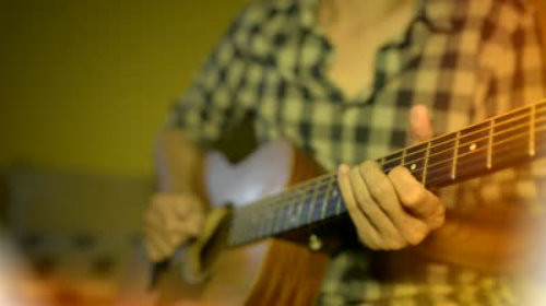 Mature adult playing guitar with passion