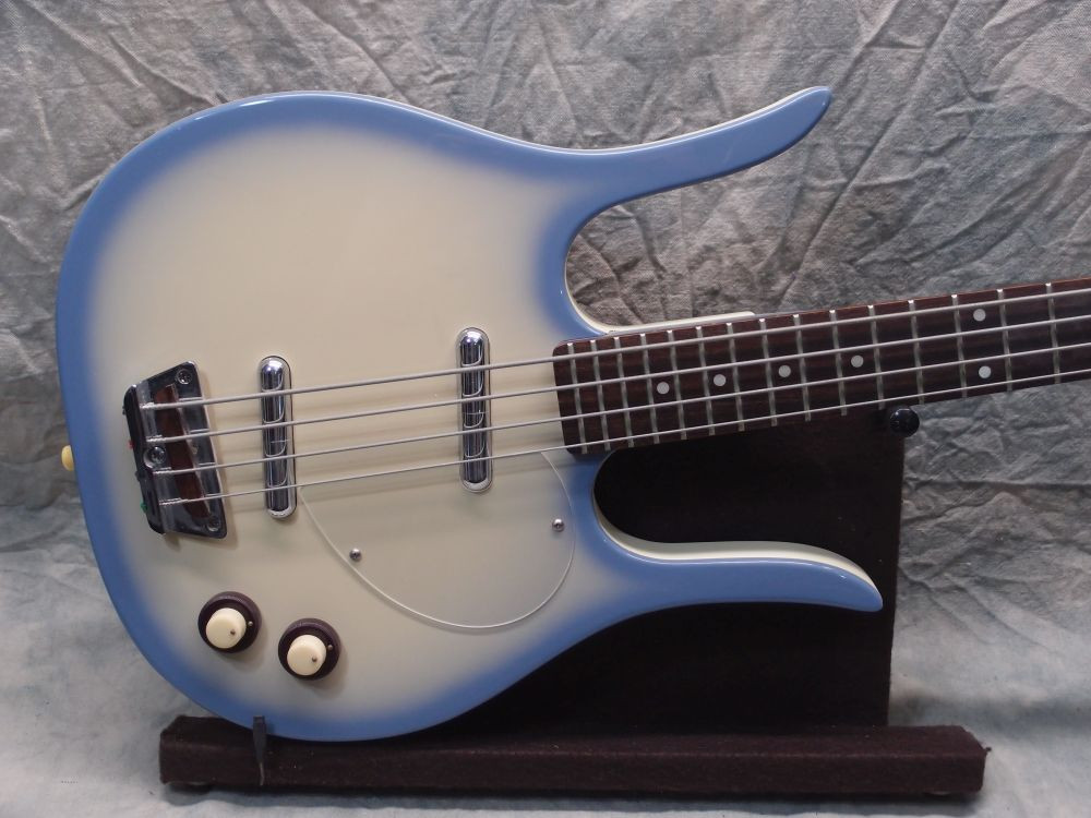 Close-up view of the Danelectro Longhorn Bass guitar headstock, highlighting the tuners and headstock shape
