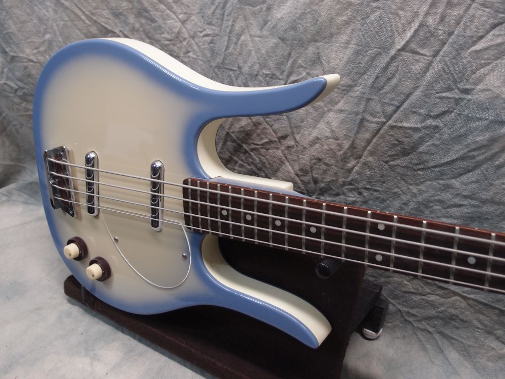 Detailed image of the Danelectro Longhorn Bass guitar body, showcasing the finish and tolex binding