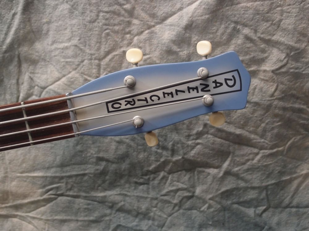 Close-up image of the Danelectro Longhorn Bass guitar body binding, highlighting the tolex material
