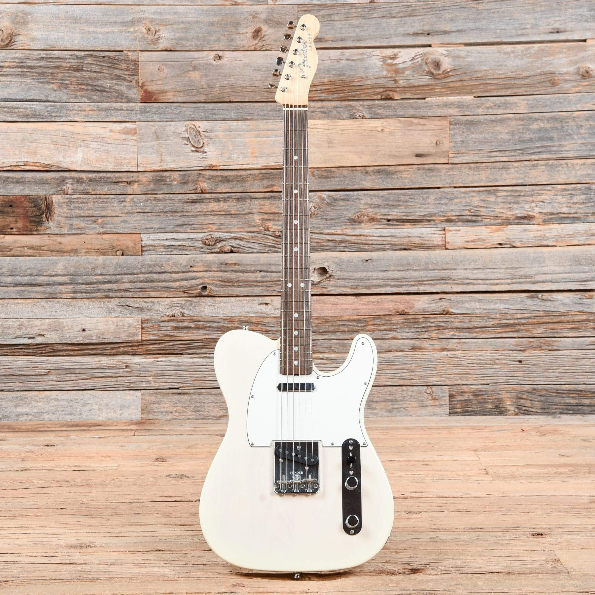 A Fender American Vintage '64 Telecaster in white blonde finish, featuring a rosewood fretboard, adding a warmer tone to the Telecaster family