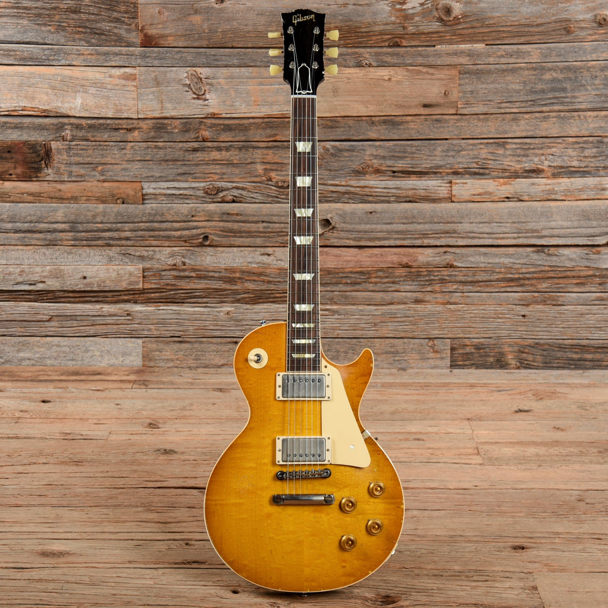 A Gibson Les Paul R8 Reissue in Lemonburst finish, showcasing its classic single-cutaway body and humbucker pickups