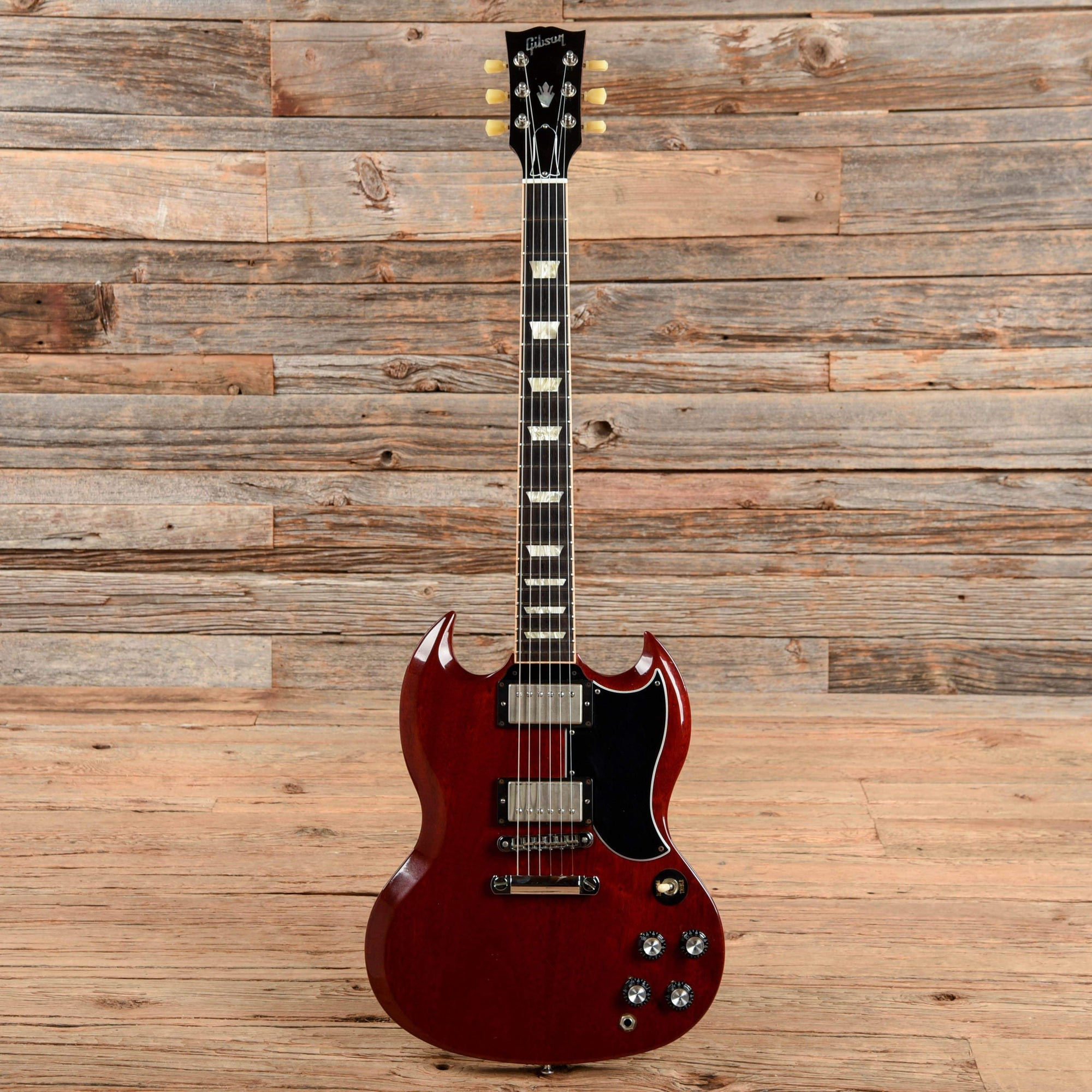 A Gibson SG '61 Reissue in cherry red finish, highlighting its double-cutaway body and powerful humbuckers, iconic for classic rock