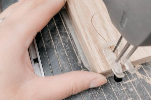 Cut the guitar holder using a scroll saw (dremel moto saw)