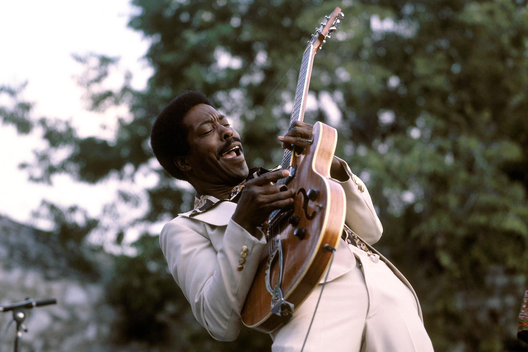 Buddy Guy performing live in Nice, France, 1978, showcasing his flamboyant blues guitar style and energetic stage presence